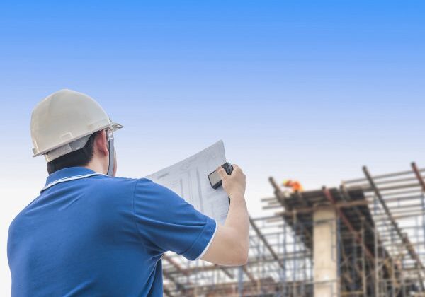 Engineer is inspecting his work in building construction site